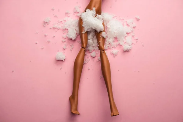 Plastic Doll Legs Snow Covered Crotch Pastel Pink Background — Stock Photo, Image