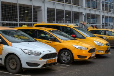 December 13, Moscow, Russia-row of yellow cars Yandex taxi clipart