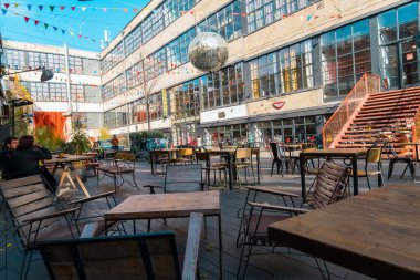 Tbilisi, Georgia, 16 December 2019 -   the yard of the creative space Factory with coffee shops and restaurants decorated with a disco ball and colorful flags