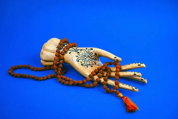 Wooden Hand Holds Rosary Bright Blue Background — 스톡 사진