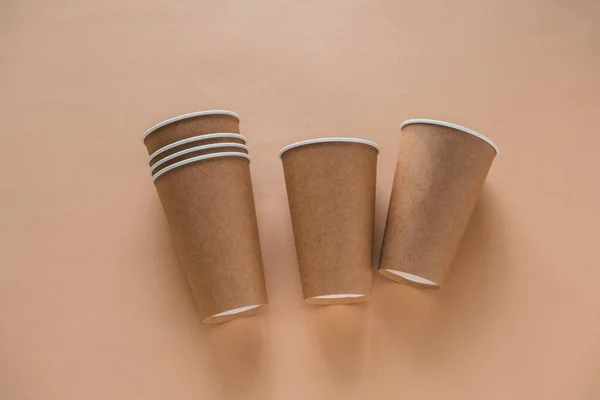 disposable paper biodegradable cup on a beige background