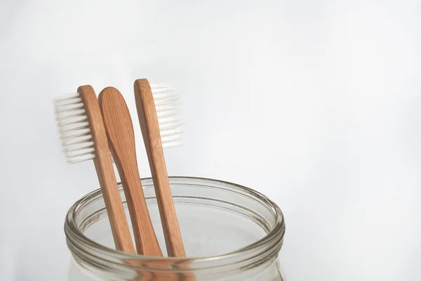 Three Bamboo Tooth Brushes Glass Jar White Background Copy Space — Stock Photo, Image