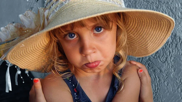 Little beautiful girl is offended and embraces herself
