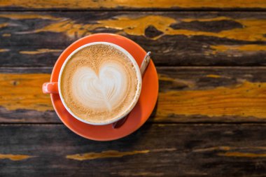 Grunge yüzey masada sıcak latte kahve sanat turuncu fincan