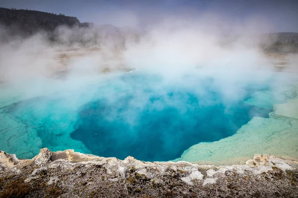 Blue geyser basin with boiling water from geothermal heat. Royalty Free Stock Photos