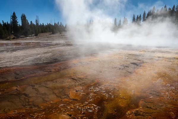 Boiling water with smoke of orange geyser basin. — Stock Photo, Image