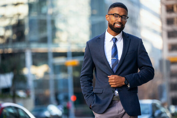 Handsome attractive cheerful african american executive business man at the workspace office