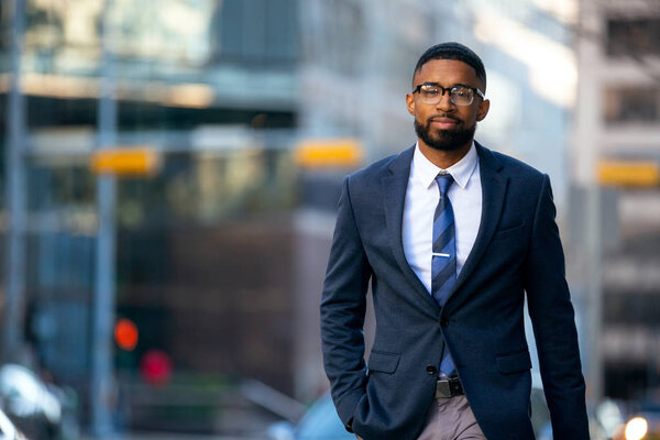 Handsome charming cheerful african american businessman in swanky modern stylish suit and tie, colorful, classy, office building