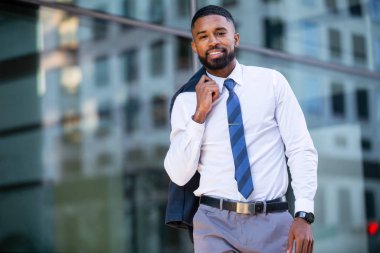 Modern fashionable african american business man portrait in urban city, walking to work in financial district