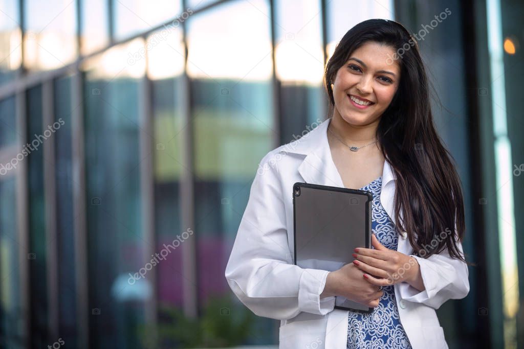 Lifestyle portrait of a professional medical psychiatrist, dental hygienist, pediatrician, doctor in white coat at hospital office