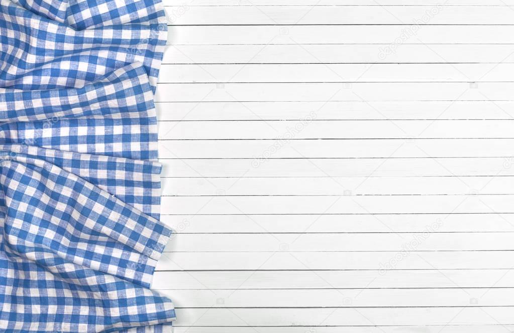 Blue tablecloth on wooden table, top view