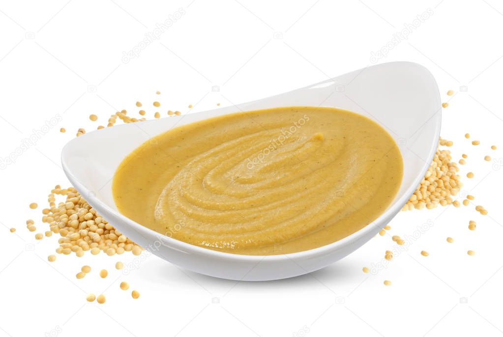 Mustard sauce in bowl and mustard seeds isolated on white background