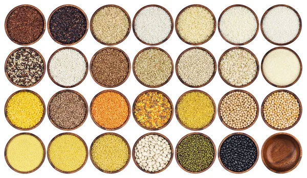 Beyaz arka plan üzerinde izole farklı kabuğu çıkarılmış tane topluluğu. Bezelye, tahıllar, pirinç, baklagiller, fasulye ve mercimek ahşap kase, üstten görünüm.