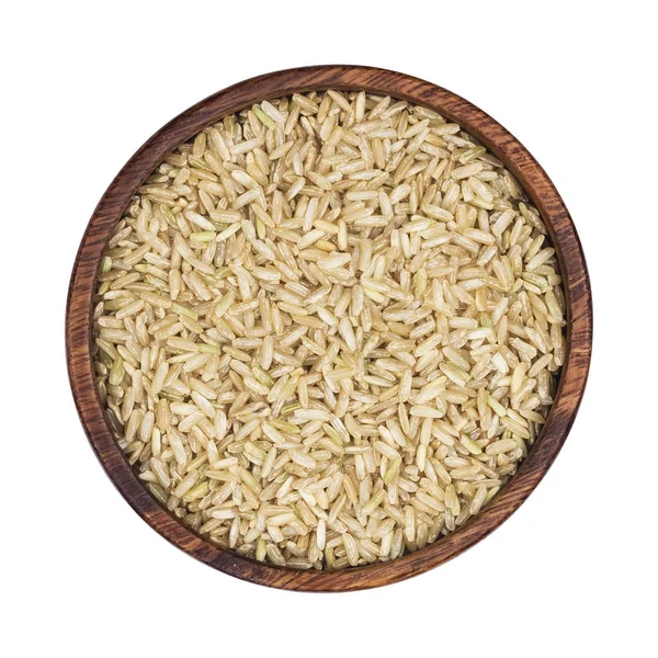 Brown rice groats in wooden bowl isolated on white background. Top view — Stock Photo, Image