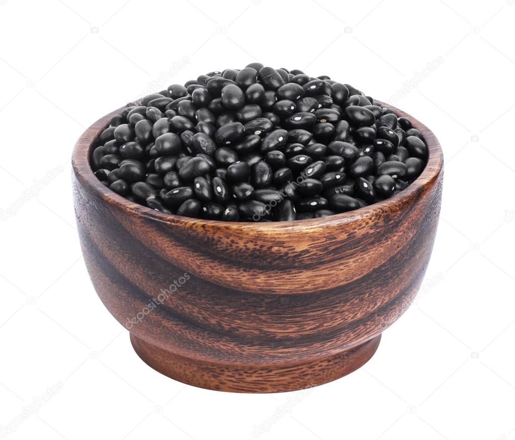 Black beans in wooden bowl isolated on white background