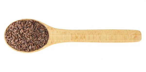 Семена льна в деревянной ложке на белом фоне крупным планом — стоковое фото