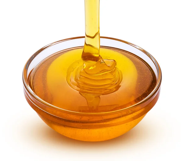 Gießen Honig isoliert auf weißem Hintergrund — Stockfoto