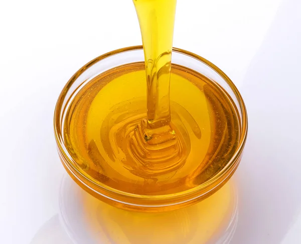 Pouring honey isolated on white background — Stock Photo, Image