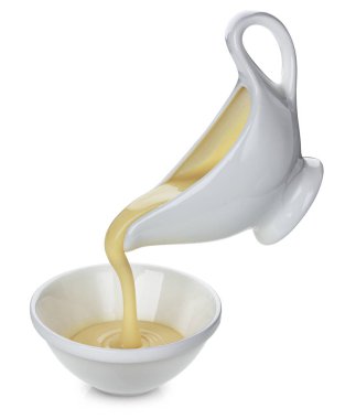 Pouring condensed milk isolated on white background clipart