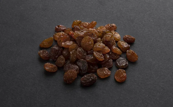 Dried raisins on black background — Stock Photo, Image