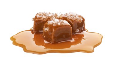 Salted toffee candies with caramel sauce isolated on white background