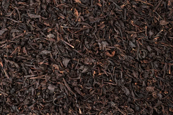 Hojas de té seco fondo o textura, patrón de té negro — Foto de Stock