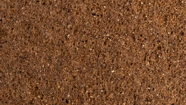 Ткань ржаного хлеба крупным планом, коричневый хлеб фон — стоковое фото