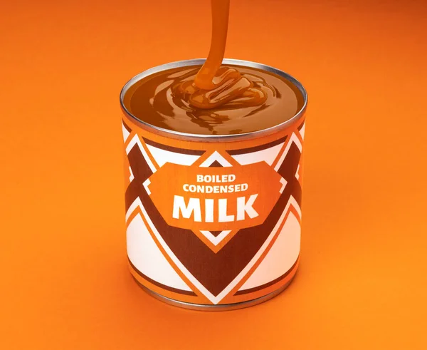 Flowing melted boiled condensed milk into can isolated on orange color background