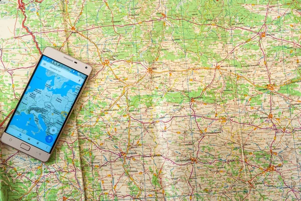 Mobile phone navigation program on a paper road map