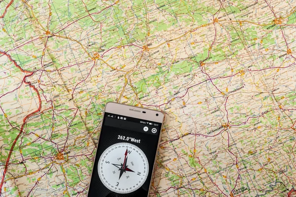 Mobile phone navigation program on a paper road map