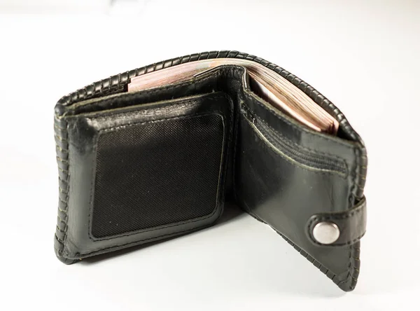 Black purse full of money tight