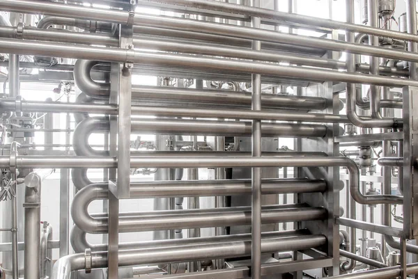 Stainless steel pipes in the factory. Construction on food produ
