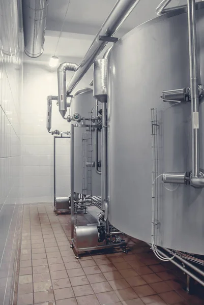 Large stainless steel barrels connected by pipes in the factory industry — Stock Photo, Image