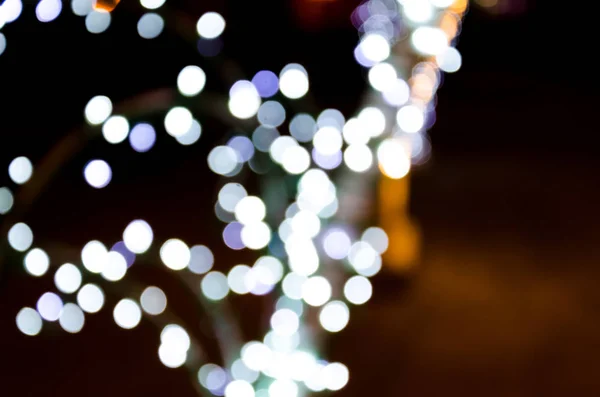 Colored lights, garlands. Blurred photo. Celebratory background. — Stock Photo, Image