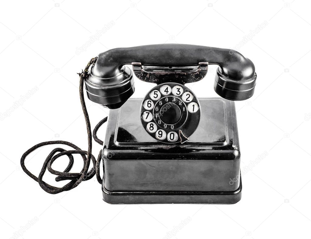Old vintage black phone on white background