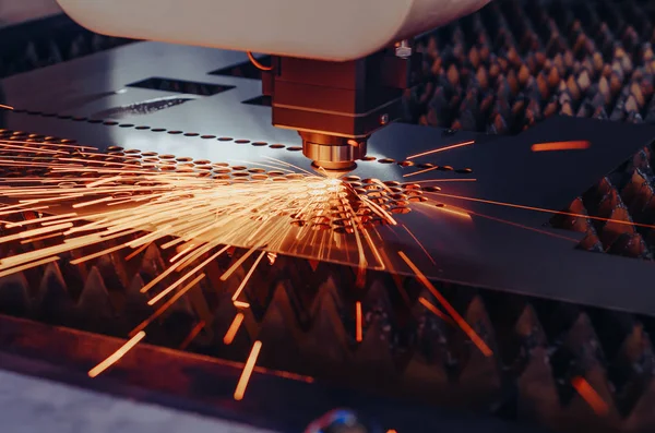 Metal lazer kesme makinesi. Lazer kafa bir kirişle çarşafı keser, kıvılcım saçar..