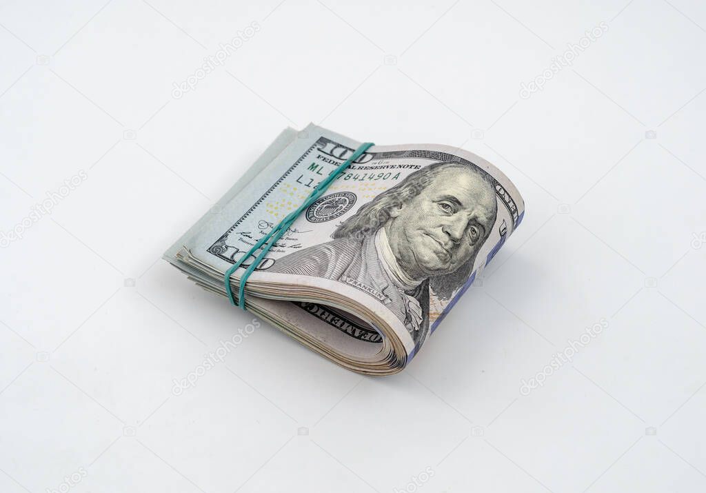 Stack of American dollars tied with a rubber band for money