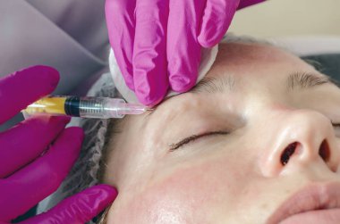 Kadın yüzü göz, şırınga, ilaç ve gençleştirme etrafında güzellik iğneleri yapıyor..