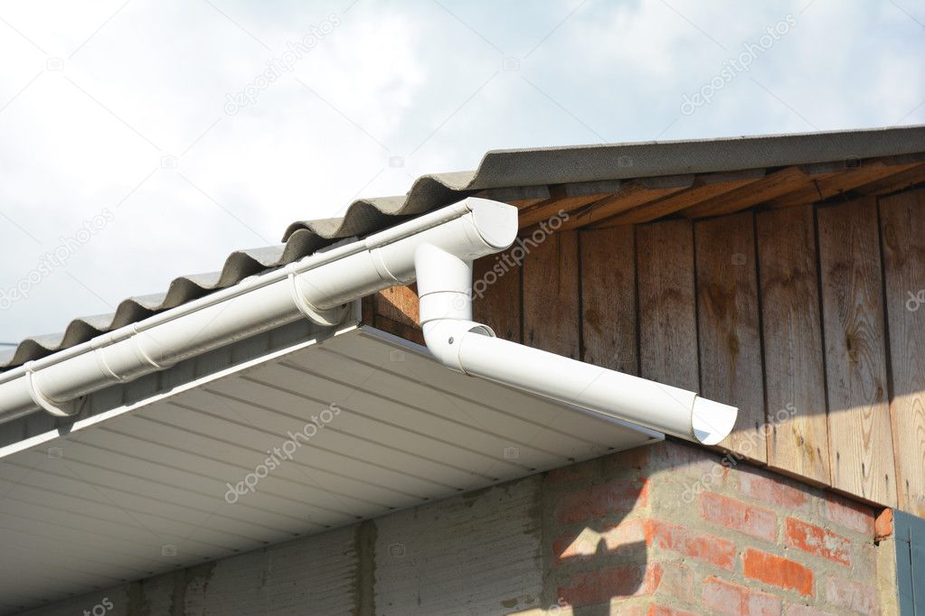 Rain Gutter with Soffit and Fascia on Garage Roof.