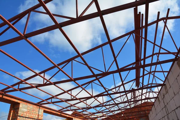 Steel roof trusses details with clouds sky background. Steel roof trusses