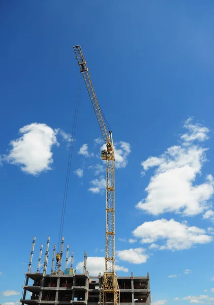 Crane Construction. Tower Crane in Construction site. Yellow crane building high rise.