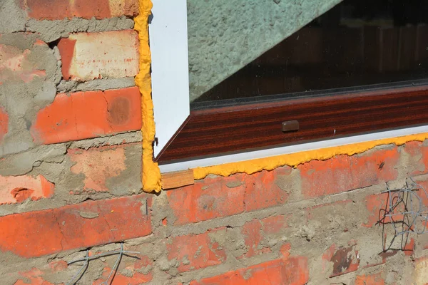 Close up on window insulation with spray foam insulation.