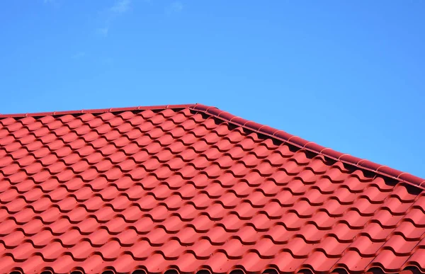 Nieuwe rode metalen pannendak huis dakbedekking bouw buitenkant. — Stockfoto