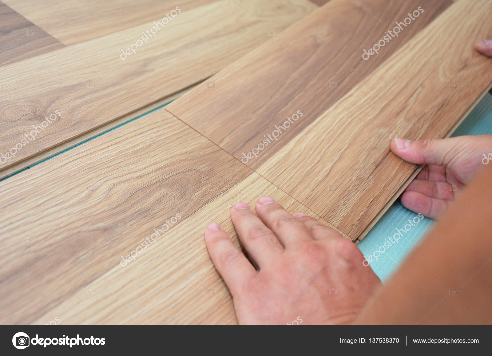 Installing, repair laminate flooring fitting the next piece Stock
