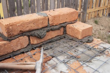 Örmek, tuğla, demir çubuklar, inşaat demiri veya takviye çelik çubukları ile.