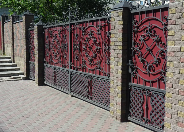 Brick  and Metal Fence with Door and Gate. Royalty Free Stock Photos