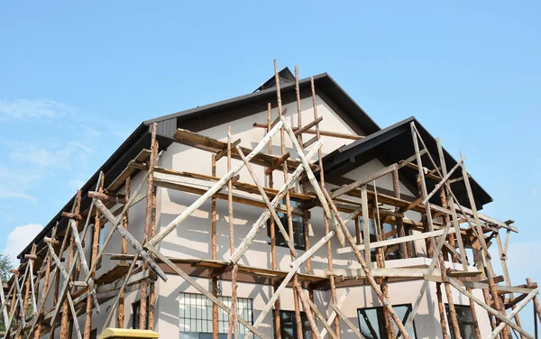 Repair, Painting and Plastering Exterior House Scaffolding Outdoor. Stucco Facade Home. Exterior Stucco - Building Conservation.