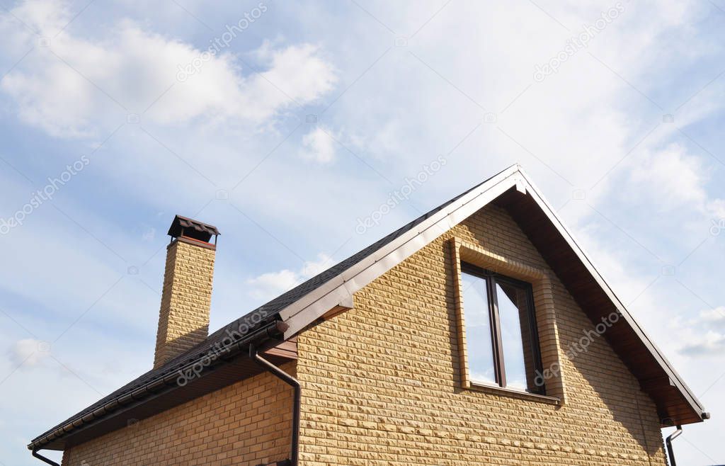 Attic construction outdoors. Roofing Construction with brick chimney