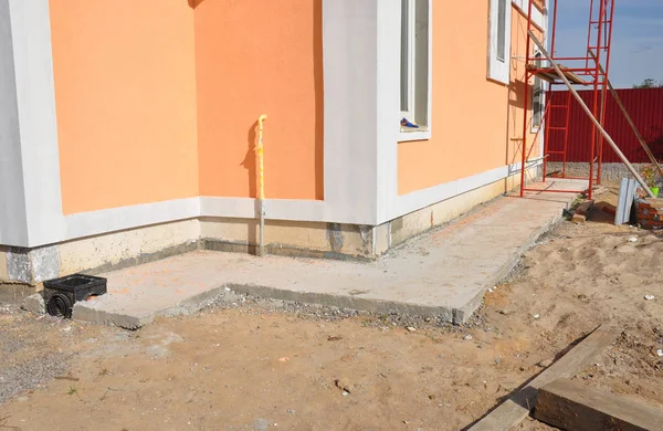 Aislamiento con membrana impermeable, aislamiento, estuco para la construcción de cimientos de la casa. Reparación de cimientos de casas, aislamiento con drenaje de plástico para tubería de cadena de lluvia . — Foto de Stock