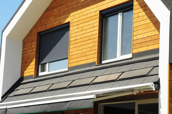 Close up on House Blinds Sun Protection Exterior with Solar Panels. Windows in New Modern Passive House Attic Facade Wooden Wall with Shutters Closed and Opened Outdoors. — Stock Photo, Image